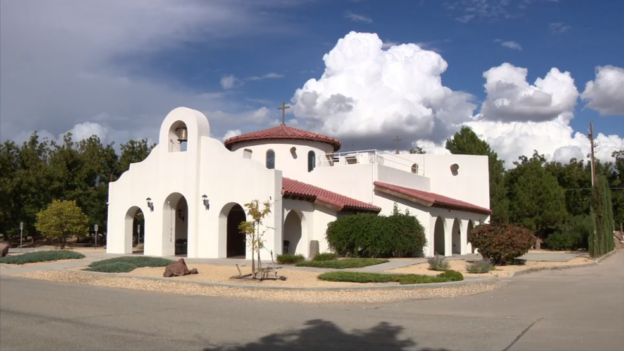 White stucco church with red tile roof